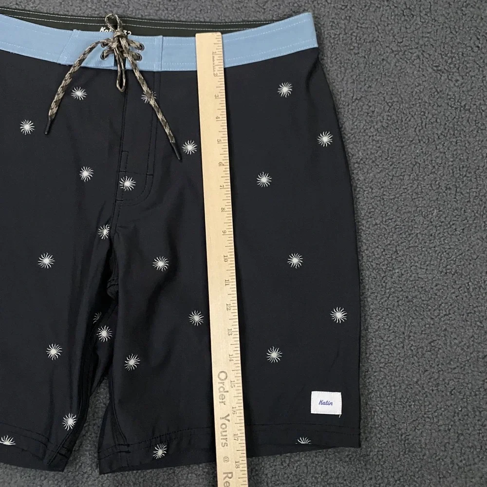 NWOT Katin Black Swim Hybrids with Light Blue Waistband & White Starburst Print